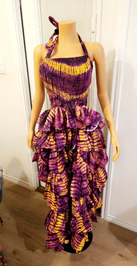 Model wearing the Zola Cocoa Step Ruffle Smokey Maxi Dress, a brown smokey Ankara maxi dress with layered step ruffles and a flowing elegant silhouette.